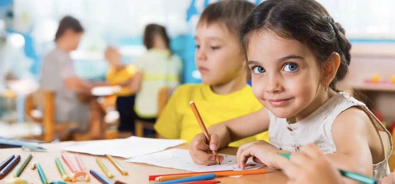 Child drawing with a crayon at Caterpillar Kidz